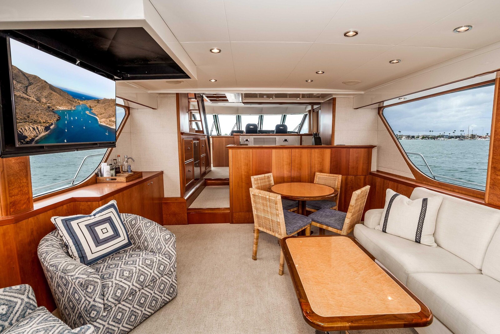 Refreshed main salon of Nordlund 74 Following Sea II with cherry joinery and updated soft goods
