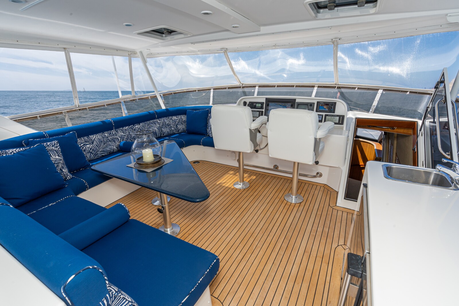 Expansive flybridge of the West Bay SonShip 78 Mahana with seating and helm